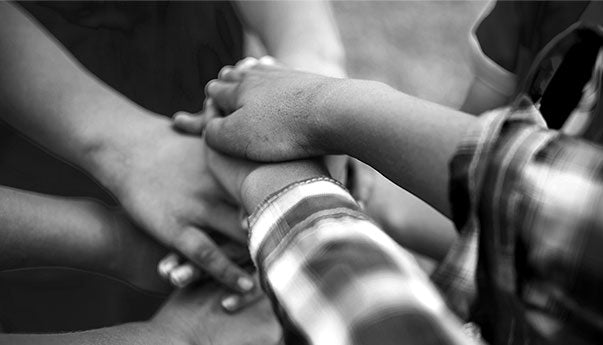 Children with hands in a pile